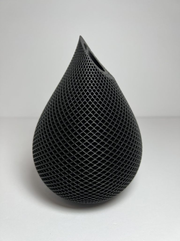A black teardrop-shaped Voronoi vase with an open lattice surface.